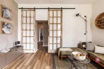 Salon z przeszklonymi drzwiami w apartamencie Orient Desert na sprzedaż w Łodzi Salon z rozsuwanymi drzwiami w apartamencie Orient Desert